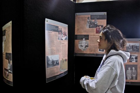 Sophomore Audrey Howarth examines the Holocaust exhibit in Karpen Hall. Holocaust survivor Walter Ziffer will speak at UNCA on Wednesday. 