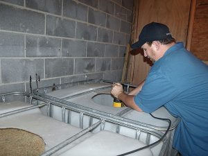 By Tina Scruggs - Staff Writer Cody Bradford mixing corn,  water, and sugar.