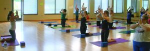 Instructor Ashley Edwards leads students and faculty participants in Yogalates, a class that combines basic yoga and Pilates practices. Photo by Harper Spires - Staff Photographer.