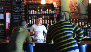 Photo by Beckett Bathanti - Opinion Editor Owner Amanda Hency talks with customers in the Mothlight at Mr. Fred’s. 