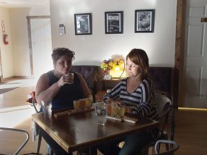 Photo by Tina Scruggs Kara Berlin and Kirsten Stalle try a flight of cider on the grand opening of Urban Orchard Cider Company last Wednesday.