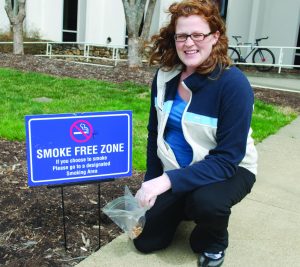 Laurie Stradley showed how cigarette butts litter the UNCA campus, even in smoke-free zones. Photo by Amanda Cline - Staff Photographer