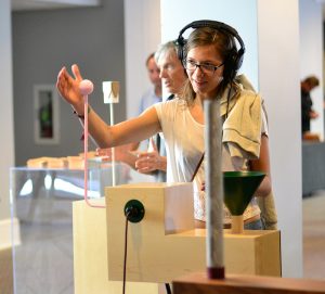 A woman plays a Theremin at a 4 day exhibit at Moogfest.  photo by Brian Vu