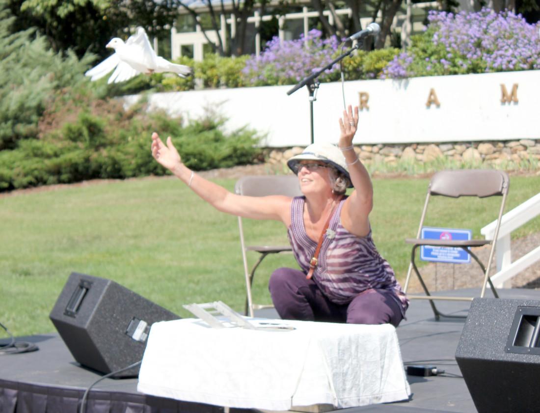 Julia Gaunt, owner of Asheville White Dove Releases, uses her doves as a symbolic gesture last Sunday. Photo by Amanda Cline - Staff Writer