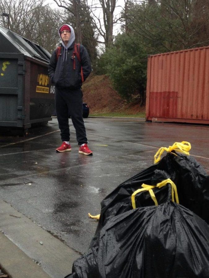 Lee Elliott posing by a trashy dumpster at The Grove apartments