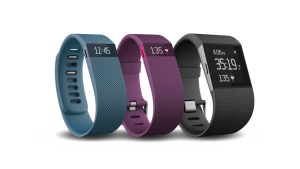 Various Fitbit fitness watches display their functions. From left to right: Charge, Charge HR and Surge.