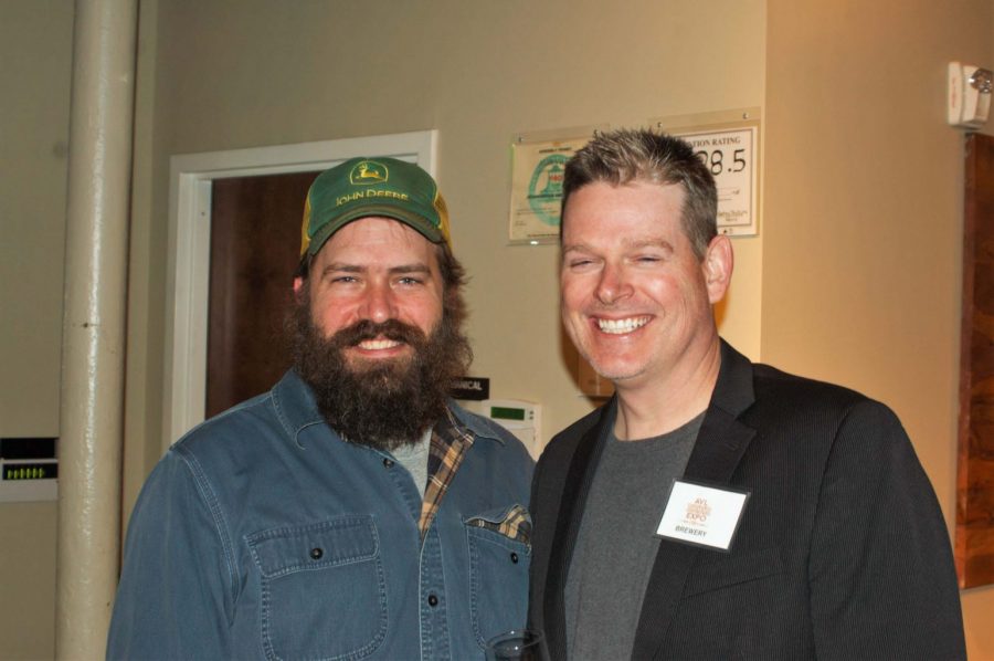 Noah McIntee (left) and Kevin Sandefur (right) flash a smile while enjoying local beers at the AVL Beer Expo Saturday night. Photo by John Mallow.