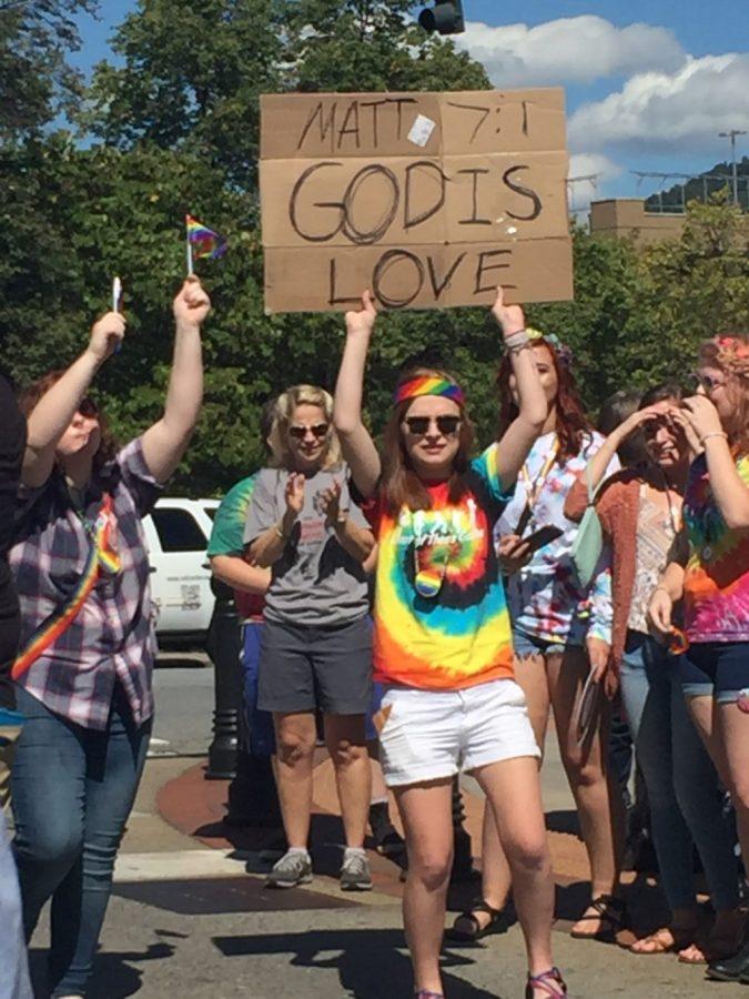 Blue Ridge Pride attendees combat religious protestors with messages of love.
Photo by Catherine Pigg.