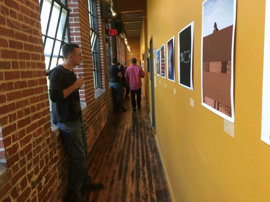Eric France takes in his art and the work of others at #AVLGLITCH at Revolve in the River Arts District of Asheville. Photo by Karrigan Monk.