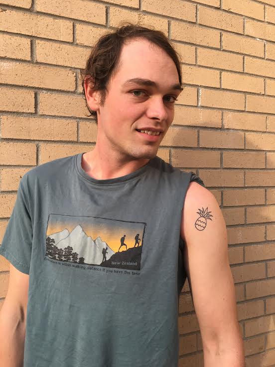 Thomas Smith shows off his pineapple tattoo, what he calls the coolest looking fruit. Photo by Karrigan Monk.

