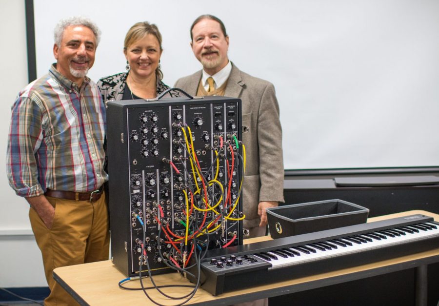 Mike Adams, left, of Moog Music, joins UNC Asheville music faculty members Melodie Galloway and Wayne Kirby, standing with the new Moog Model 15. Photo provided by UNCA.