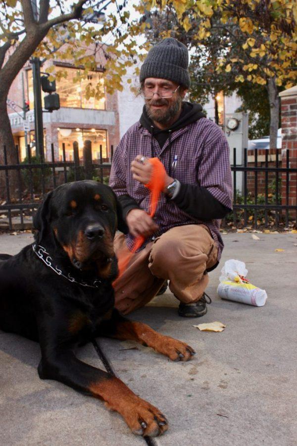 Pictured here with his dog Charlie, Sundance Henson says that living in Asheville is no longer sustainable. Photo by Dusty Albinger.