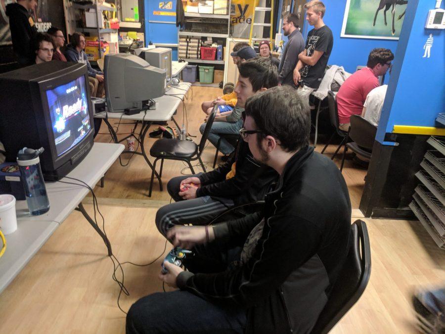 Stuart Pelletier and other students gather at GameXCape for a Super Smash Bros. Melee tournament. Photo by Martin Phillips 