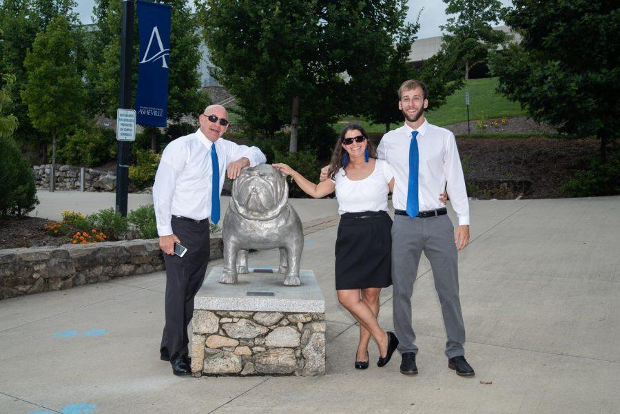 Head Coach Elizabeth Lykins stands between Assistant Coach Marty Moran, left, and Assistant Coach Daniel Dozier for a staff picture. Photo courtesy of UNC Asheville Athletics 