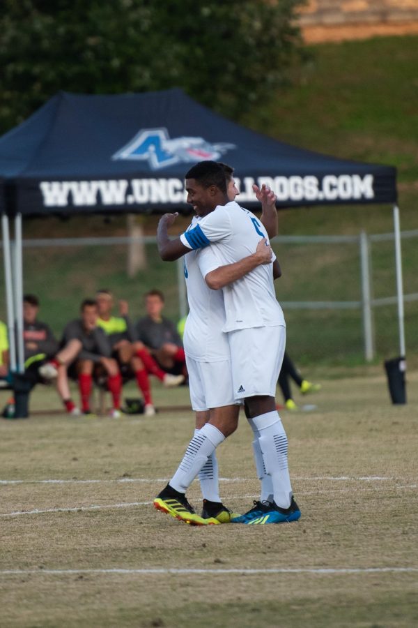 Joseph LaCasto (left) and Brandon Millington share a hug after a goal is scored. Photo by Aaron Etheridge 