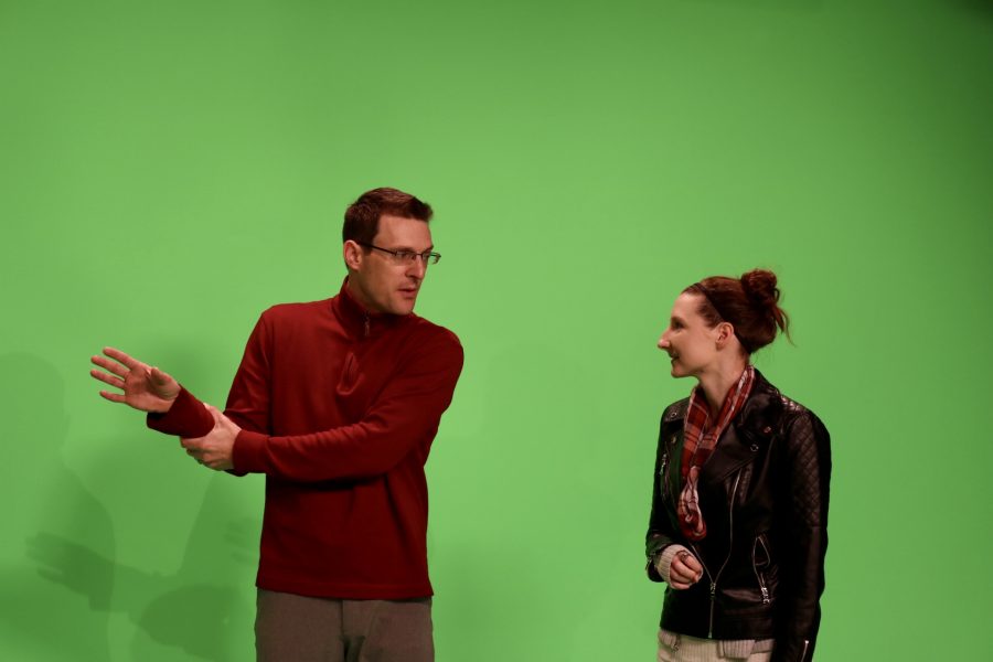 Photo By Emily Arismendy
Chief Meteorologist at WLOS news station Jason Boyer advises UNCA Junior Angela Gambino on her stance and positioning during her broadcasting project. 