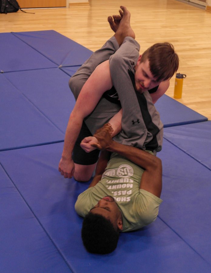 Photo by Ezekiel Ballard
Myles Thomas, a senior and president of the Brazlilian Jiu Jitsu club at UNCA,
teaches David Hallyburton a way to get yourself out of a pin.