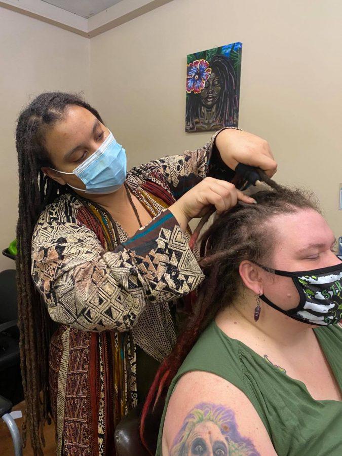 Provided by Ong Yang. Jazmin Whitmore (left) styling associate Moon Arrowood’s hair in Whitmore’s
shop.