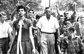 Stephanie Bridgwaters father, Dr. Edwin Thompkins, escorts Dorothy Counts-Scoggins into Harding High School in 1957.