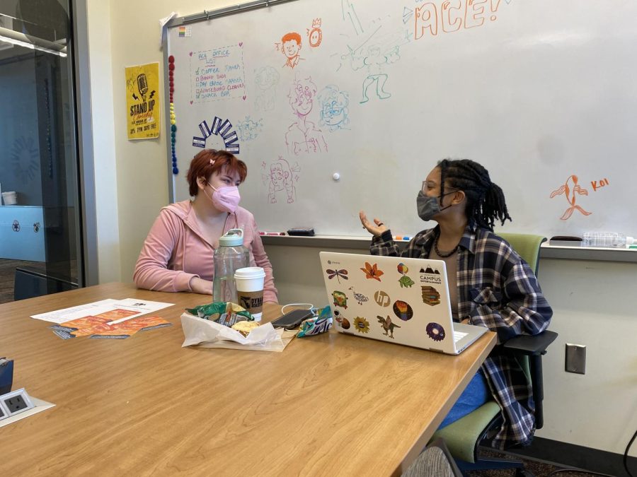 Ava Wolchesky (left) and Jada Smith (right) discuss upcoming plans within the Asheville Campus Entertainment office. 
