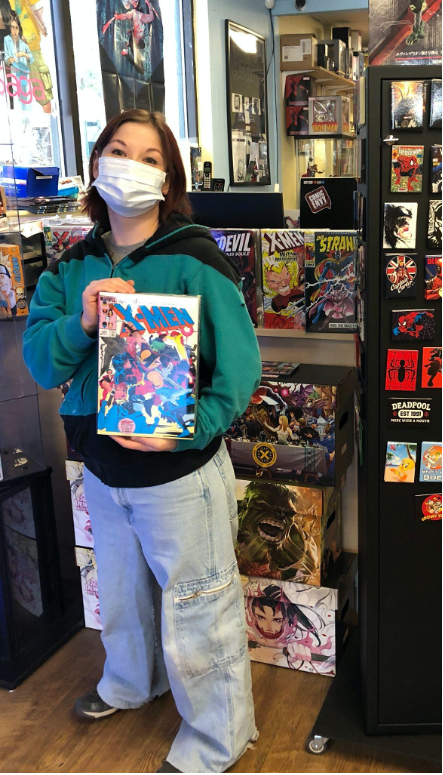 Allison Jenkins proudly shows off a compendium of her favorite series of X-Men.