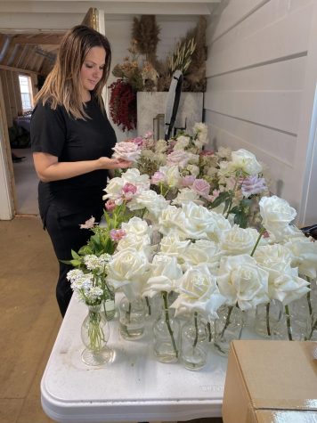Daria Krasnov looks at flowers in her studio.
