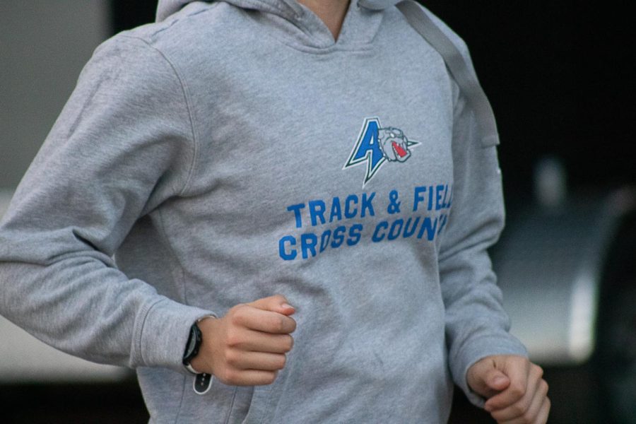 UNC Asheville womens cross country junior, Amanda Orban, wears a UNCA Cross Country sweater during her run.
