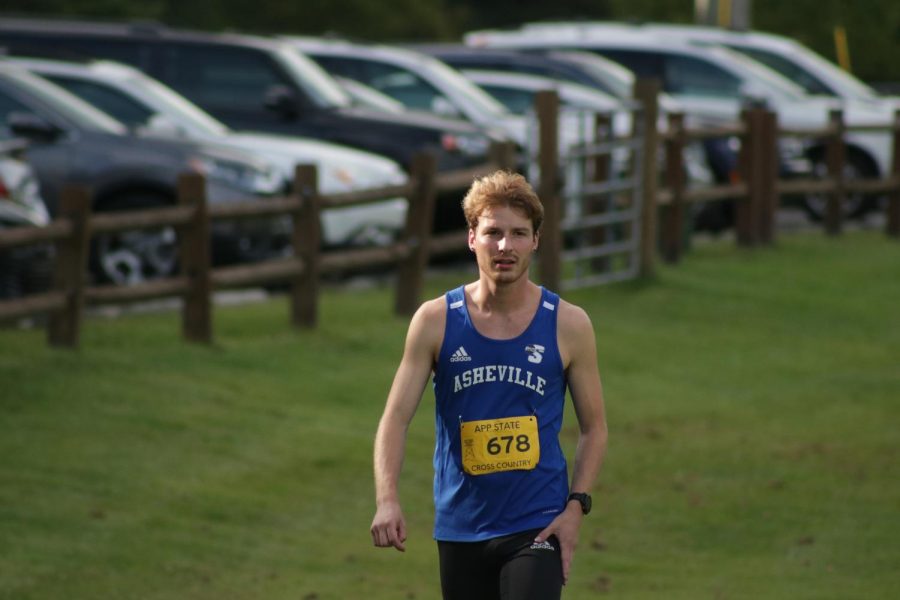 UNC Asheville mens cross country junior Adam Hessler warms up for the race at the Covered Bridge Open on Sept. 2.
