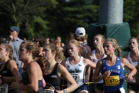 UNC Asheville women's cross country freshman Emma Kennett runs past a pack of people at the Covered Bridge Open on Sept. 2.

