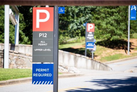 Parking signs across campus show designations for each lot. 