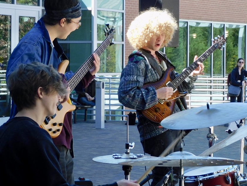 The UNC Asheville instrumentalists having fun playing a funky groove at Reed Plaza. 
