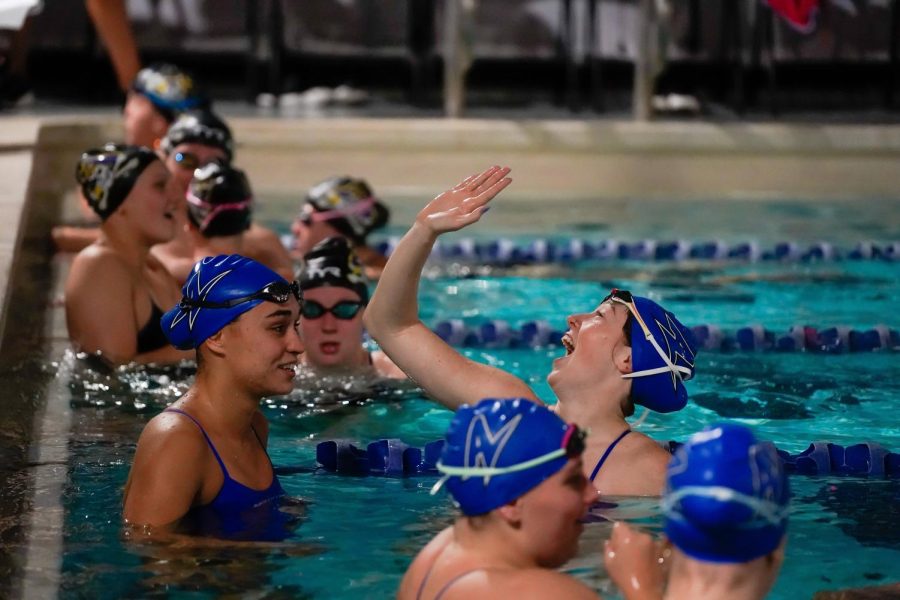 Junior Abby Parks and Freshman Anna Marcotti celebrate in the pool after UNC Asheville took the lead late in the meet. 
