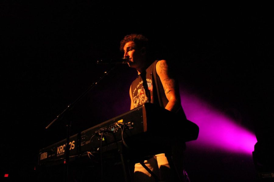 Jordan taps keys and sings.