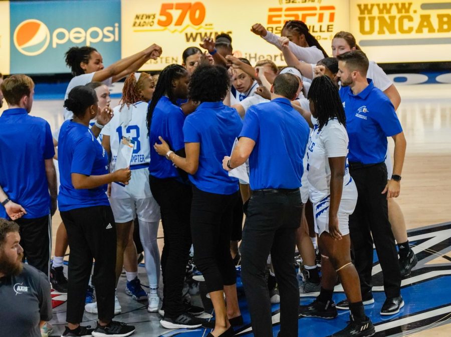 The UNC Asheville Women’s Basketball team huddle at halfcourt after their season opening 79-25 victory over Converse on Nov 7. 

