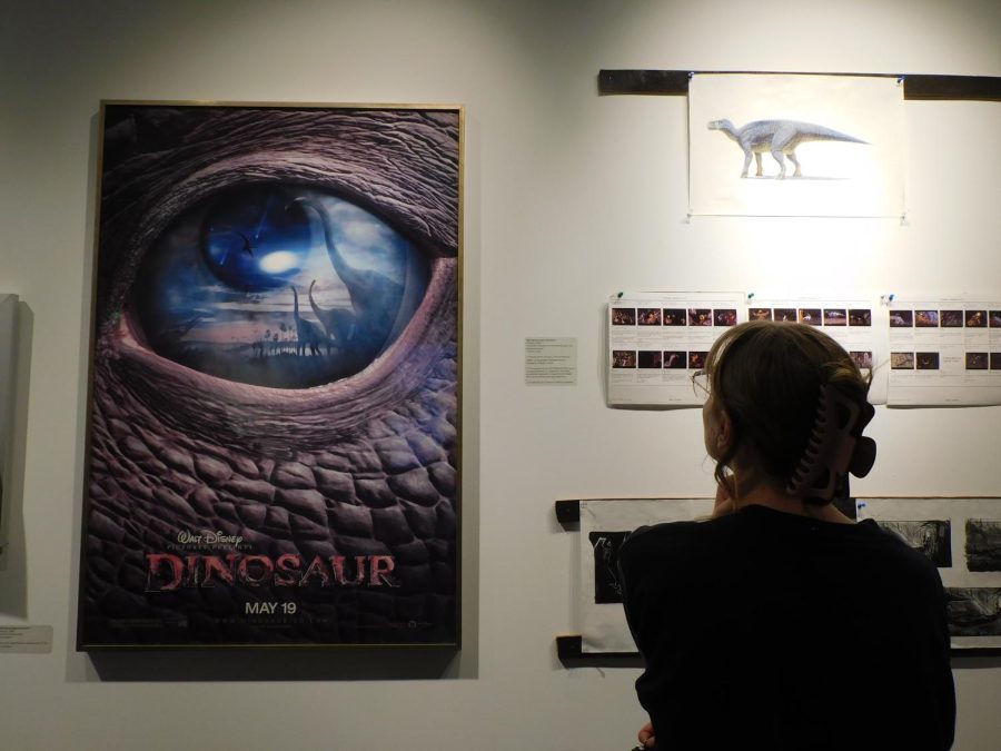 An exhibit sightseer looking at the work behind the film Dinosaur. 