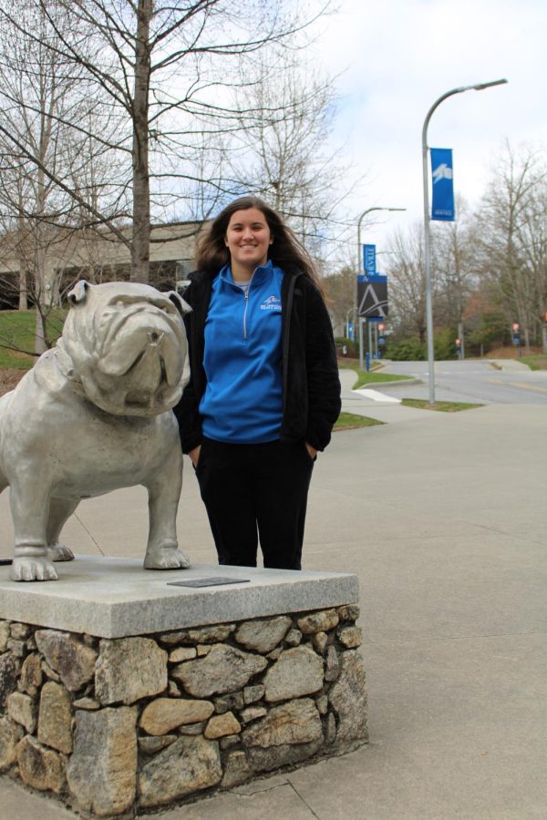 Isabela Vieira next to the bulldog statue outside of the Sherrill Center.