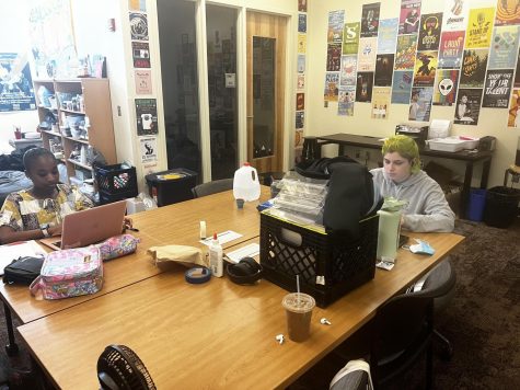 Indigo Lesser and Ziyanah Alexander complete homework while at their jobs in Highsmith Student Union.