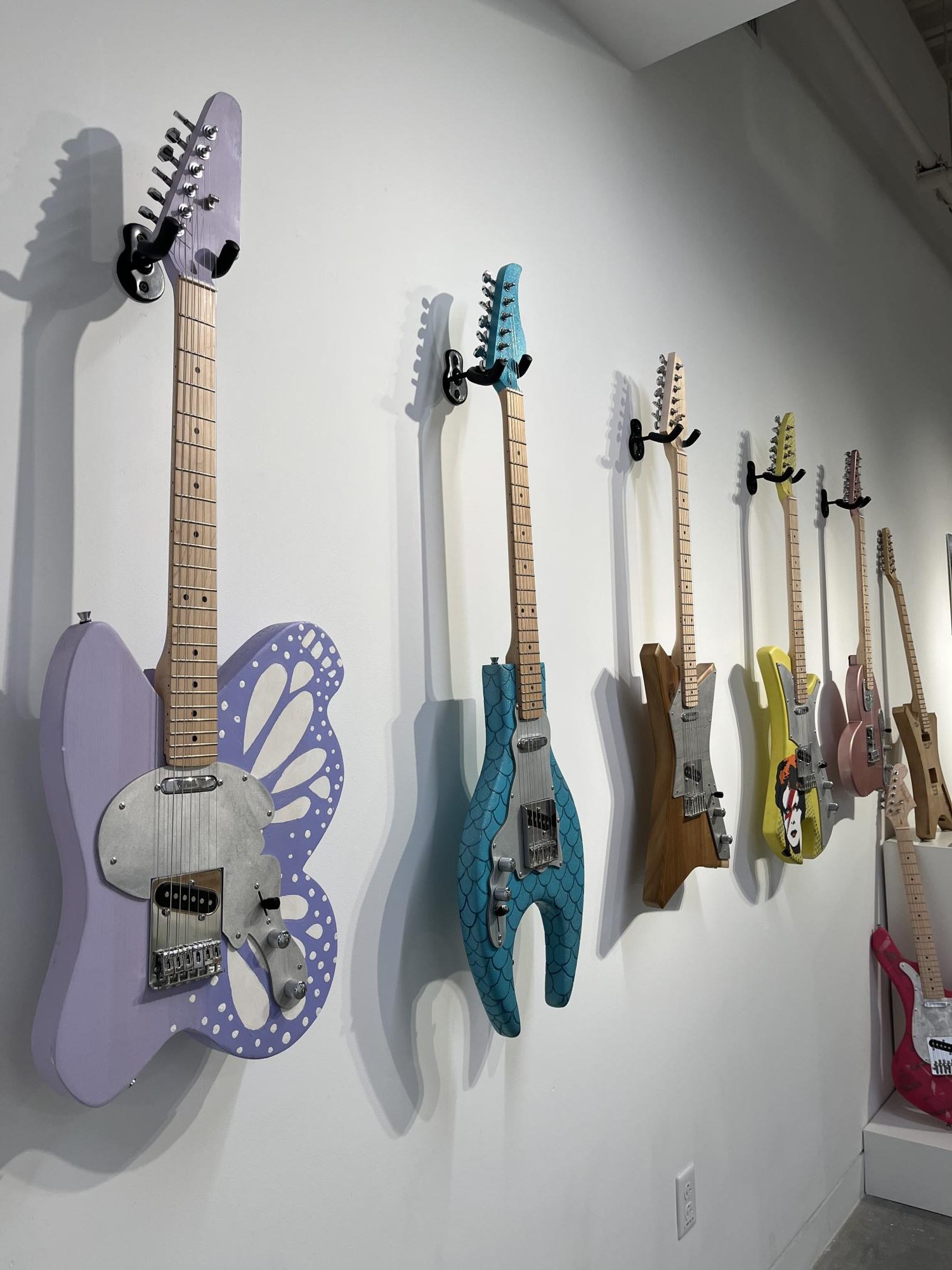 Attendees of the exhibit were met with this guitar display upon entering the gallery. 
Photo courtesy of Amanda Simons, STEAM faculty