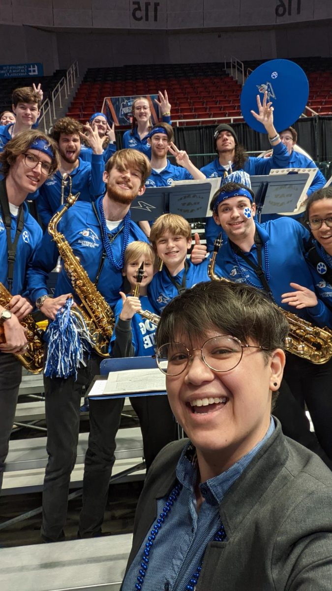 Dr. Eng posing with the UNCA pep band for a selfie. 