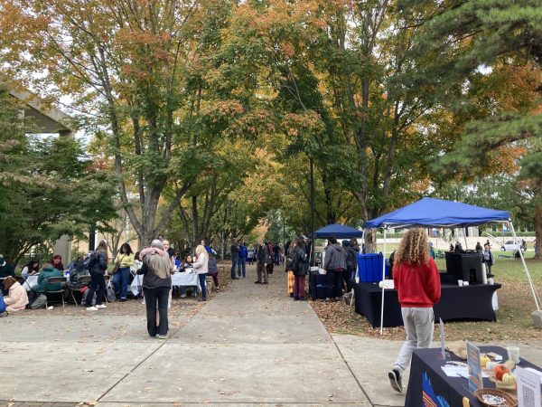 Students and faculty alike engage in fellowship under the maples.