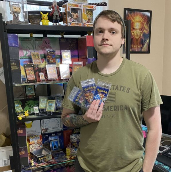 Zack Hall showing off his collection of Pokémon playing cards. 