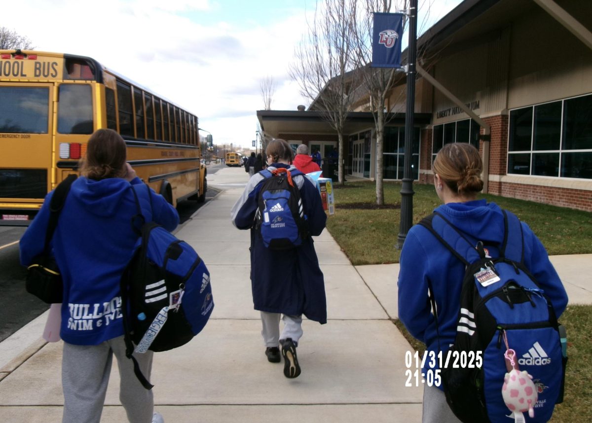 Athletes on the UNCA swim and dive team walk into a meet at Liberty University.