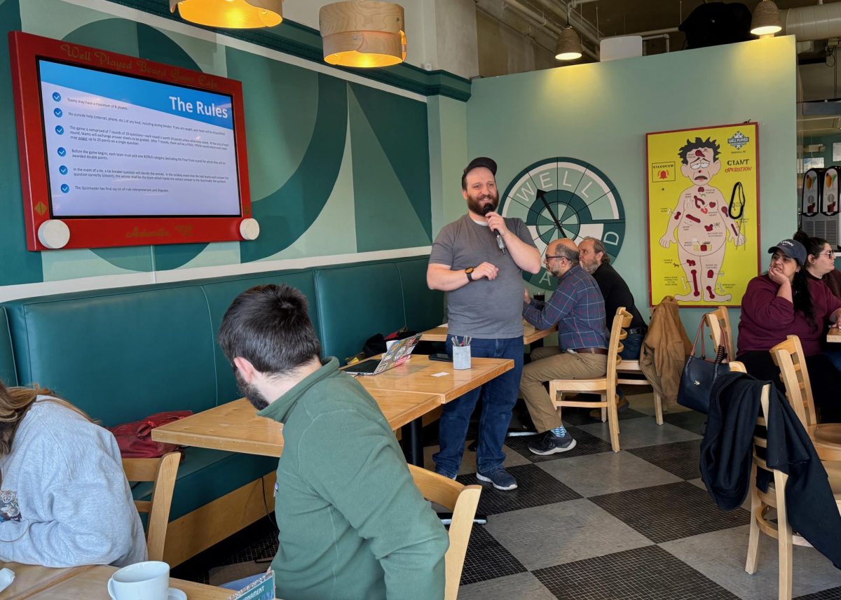 General Manager Mike Belsole warms up the crowd at the Sunday Trivia Brunch at Well Played Board Game Café.