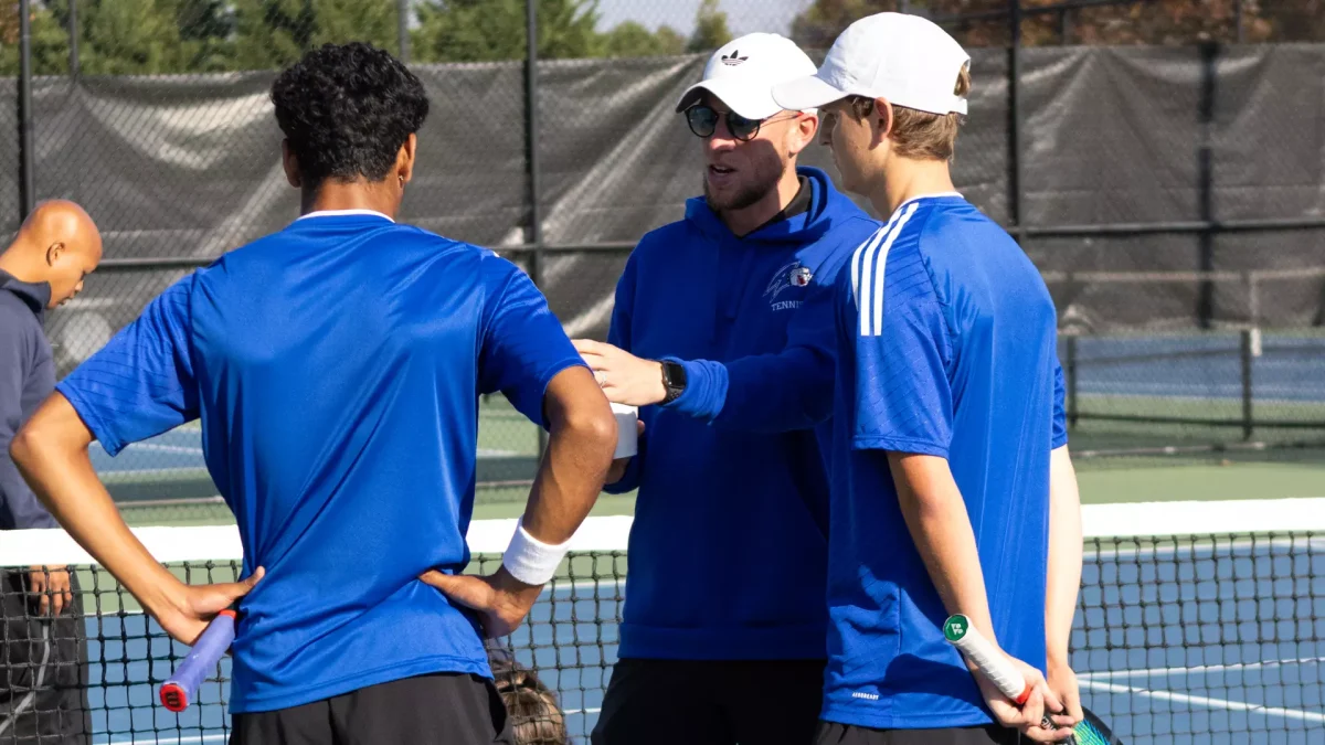 Head coach Matt Frost engages tennis players