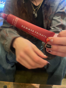 A customer holds their freshly-used Summer Fridays Lip Butter Balm.