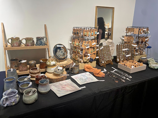 Ashley Heradia, a BFA student in the ceramics department, displays the jewelry and pottery she made in the UNCA Arts & Ceramics sale.
