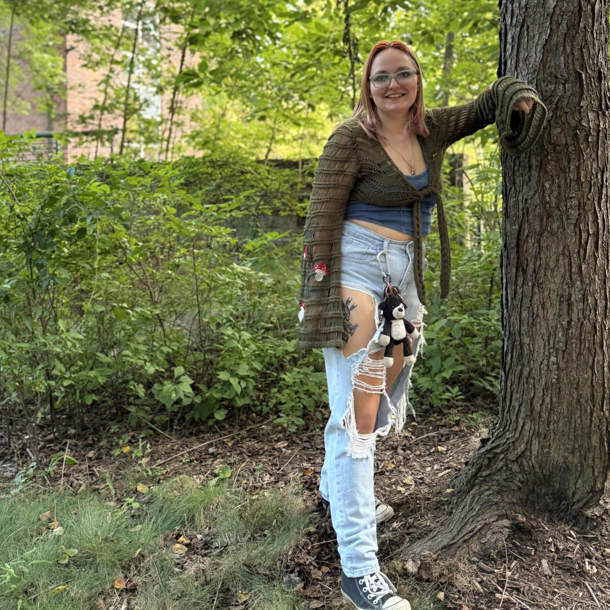 Rhiannon Sullens, a biology and environmental science student, under a maple tree.