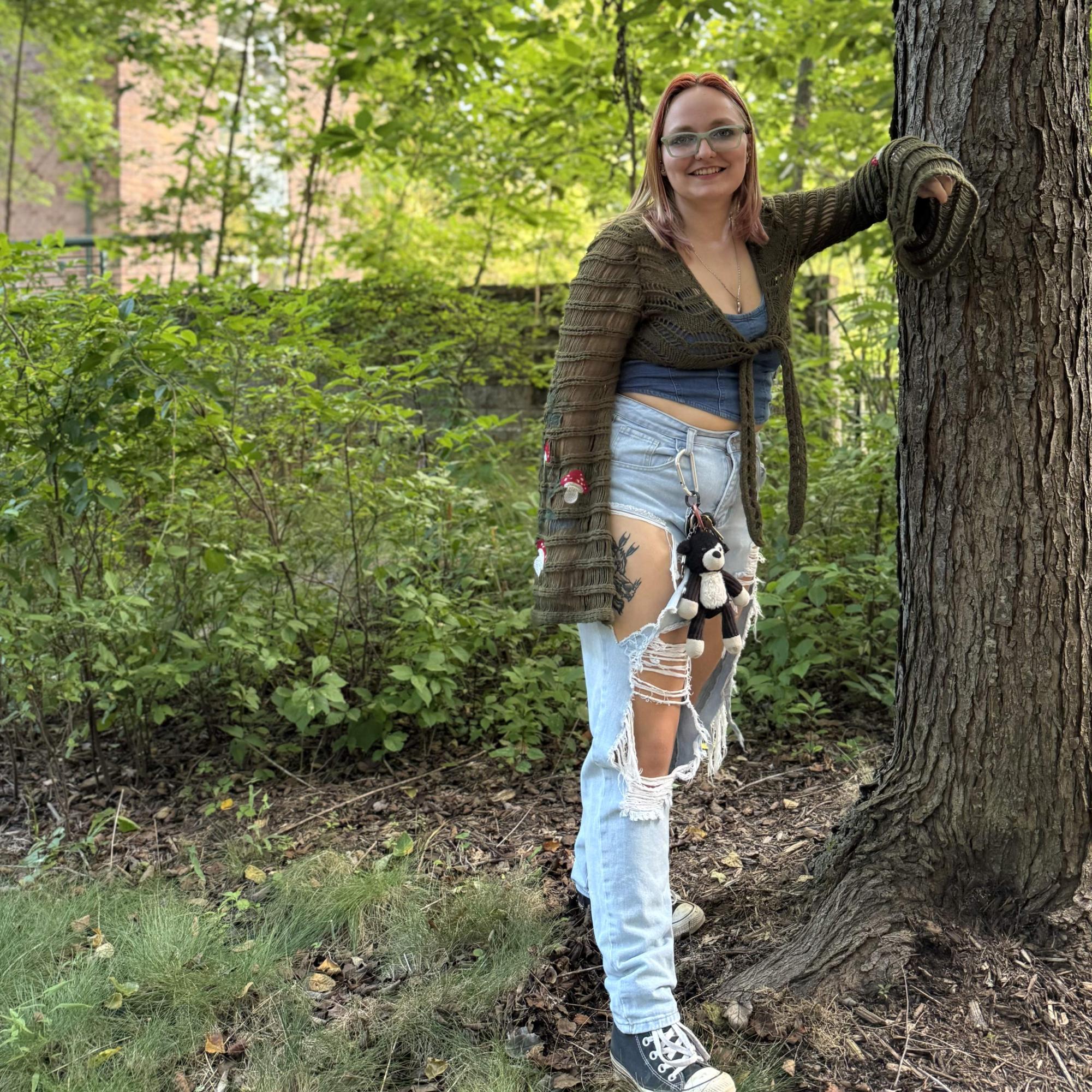 Rhiannon Sullens, a biology and environmental science student, under a maple tree.