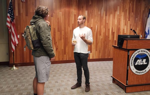 Jason Perry speaks with a student after his speaking session.