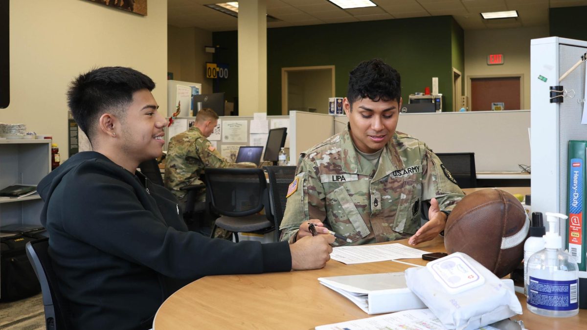 U.S. Army Staff Sgt. Neythan Lipa, a recruiter at the Asheville Army Recruiting Station, speaks with Reyii Rivera, a recruit, about joining the Army in Asheville, North Carolina.
